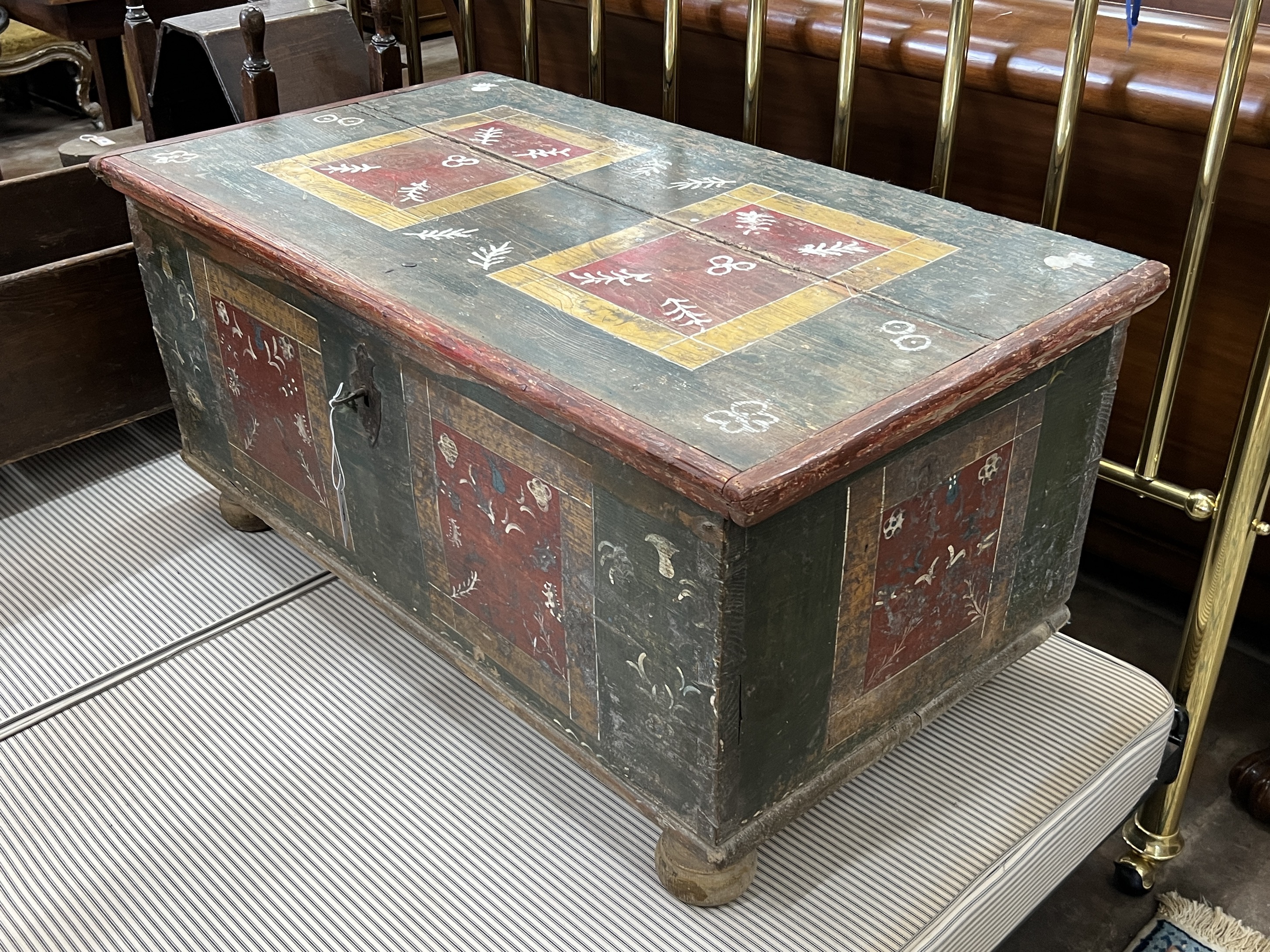A 19th century Swiss painted pine trunk, width 110cm, depth 60cm, height 51cm